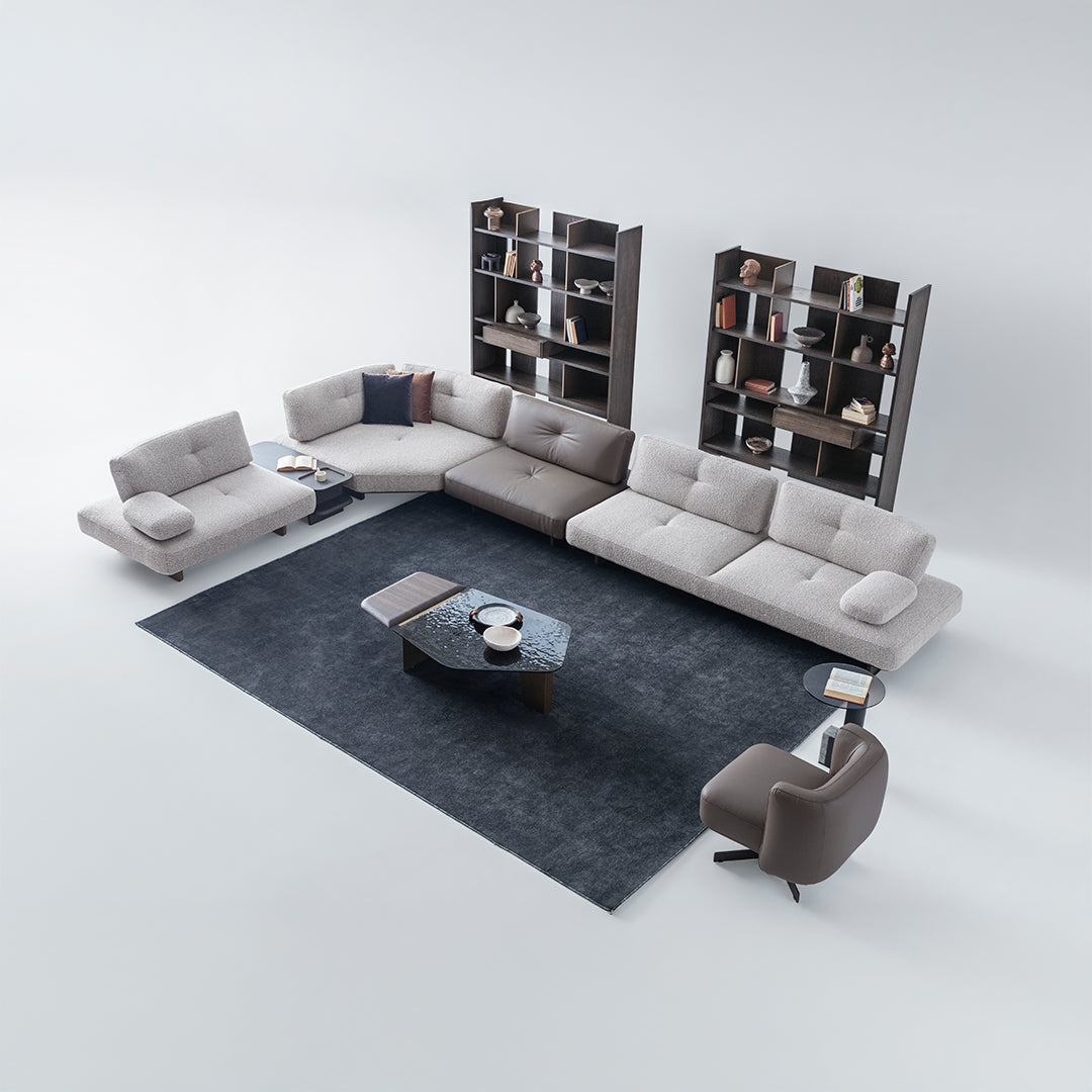 Modern living room with a gray sectional sofa, armchair, and coffee table on a white background